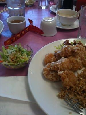 Small salad and soup in background that comes standard with all meals.