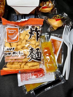 Sauces, fortune cookies and crispy noodles with take out order