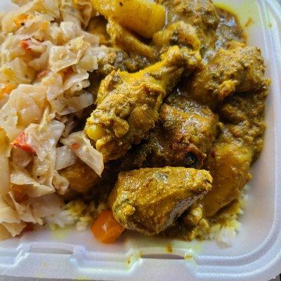 Curry chicken on a bed of jasmine rice with cabbage