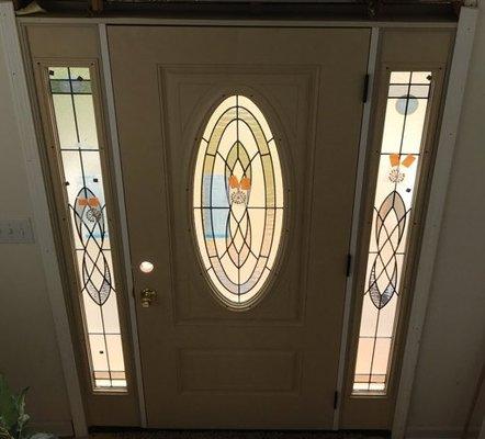 traditional entry door with stained glass inset and sidelights