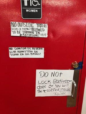 Notice the tape across the  lock on the women's bathroom door, and the sign stating the lock can't be used.