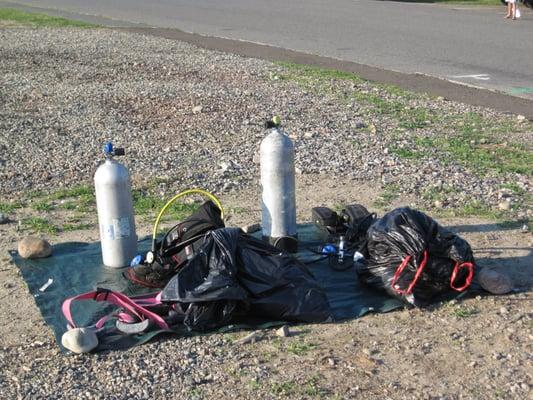 Setting up rental equipment at open dive site.