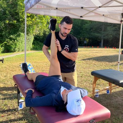 Coach Rob stretching runners at the "Run to the Pump" inaugural race