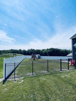 White vinyl privacy, 6' fence and 4 1/2 foot decorative aluminum black fence.