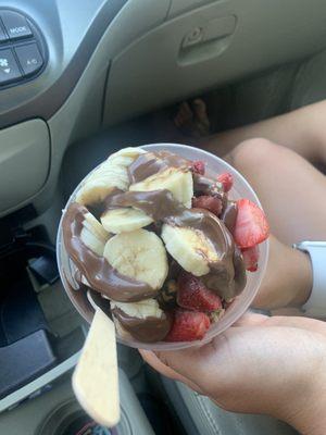 Nutella spread onto bananas, strawberries, and açaí base.