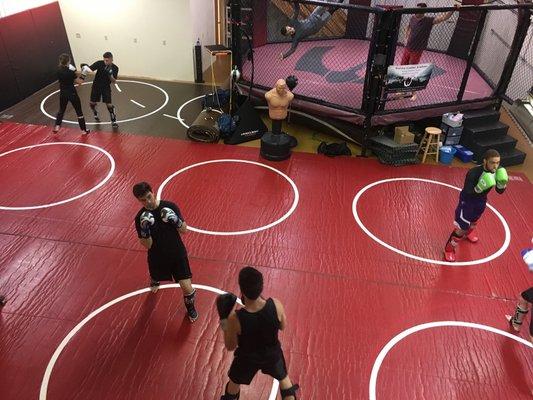 The mat space and cage at the Academy.