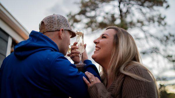 Newly Weds share a glass of champagne after cutting their wedding cake.