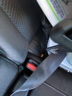 Crumbs behind car seat. How lazy can you be to not even move the car seat a little bit.