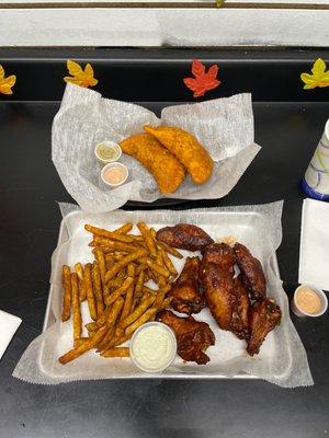 Wings w/fries and that special sauce . Beef and chicken empanadas.