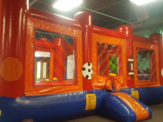 Bouncy house with balls and it has hoops to throw the balls in. They are not hard balls.