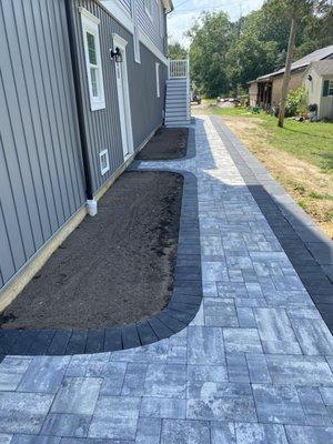 Another view of the paver walkways with a retaining wall