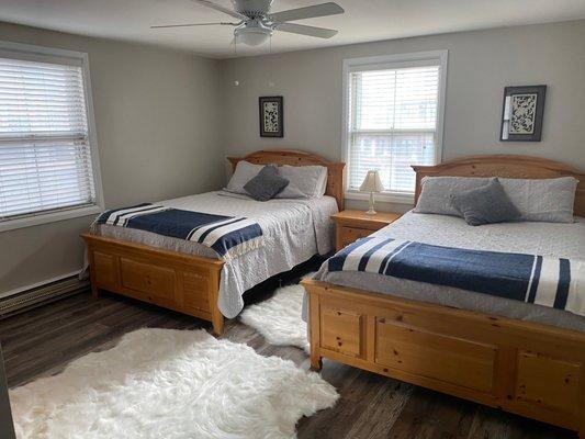 2nd bedroom has 2 queen beds, TV, dresser, ceiling fan and its own bathroom