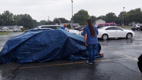 Kristen from Karns went inside and found a tarp big enough to cover his whole car until AAA gets here .