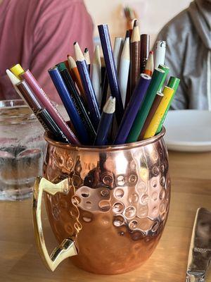 The art program begins with the Moscow Mule copper mugs. At least they know their drinks.