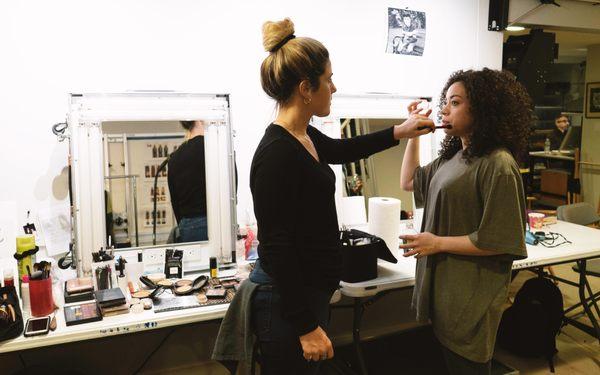 Talent in hair and makeup getting ready.