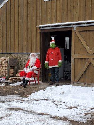 Santa and the Grinch waiting for the kids to come visit them at the farm