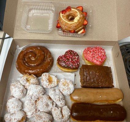 Cream puffs, cinnamon roll, choc heart donut, straw heart donut, carrot cake, maple & choc bar, glazed cronut w filling.