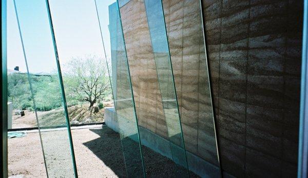 rammed earth and sloped glass