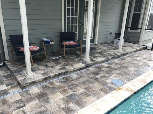 Paver pool deck and raised seating area, travertine coping