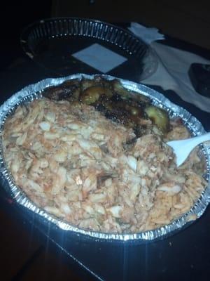 Glowing plate of Bacalao w/ rice and beans. Side of sweet plantains.