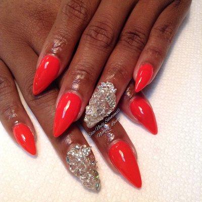 A Medium-length pointy extensions accented with a silver junk nail on each hand...