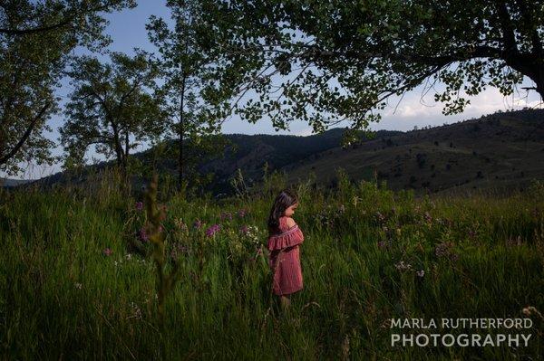 Little girl having a quiet moment during a family session at Wonderland Lake in Boulder, Colorado. Lit with professional lighting.