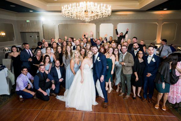 Bride and groom with wedding guests.