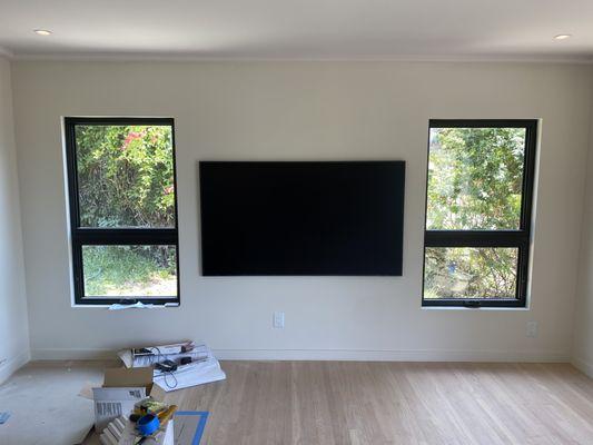 75" Samsung Frame mounted between living room windows.