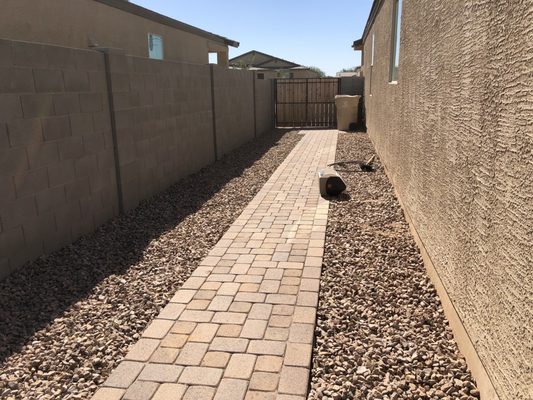 Gravel installed on side of home, paver walkway around back of home and paver garbage can landing pad