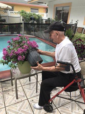 Resident of the month. He is busy outdoors with his flowers .