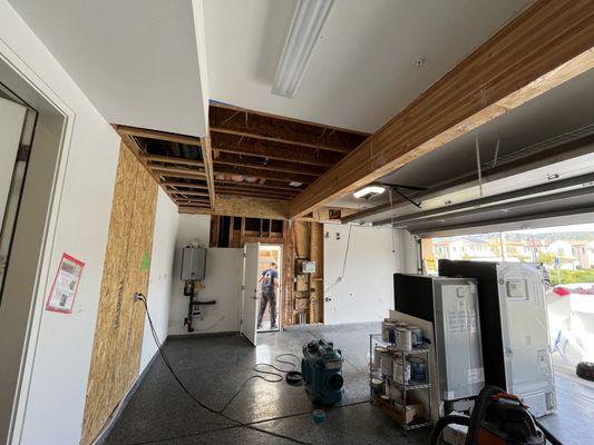 Upstairs sink overflow led to damage in the garage and adjacent rooms in home.