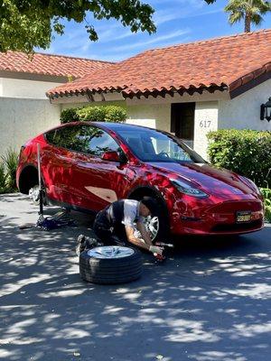 Tesla service technician Jason doing our wheel rotation at our place.