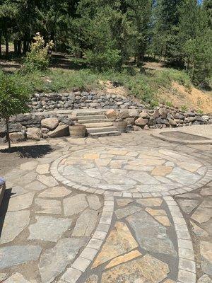 Slate patio and upper terrace with boulder retaining walls