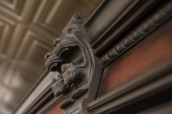 Lions head accents as part of the original pharmacy cabinetry