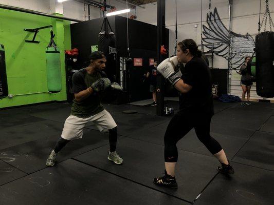 Natasha and Coach Edwin preparing for amateur fight.