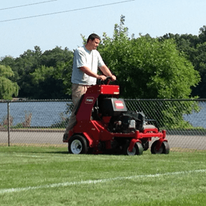 Performing lawn aeration to promote a healthy lawn.