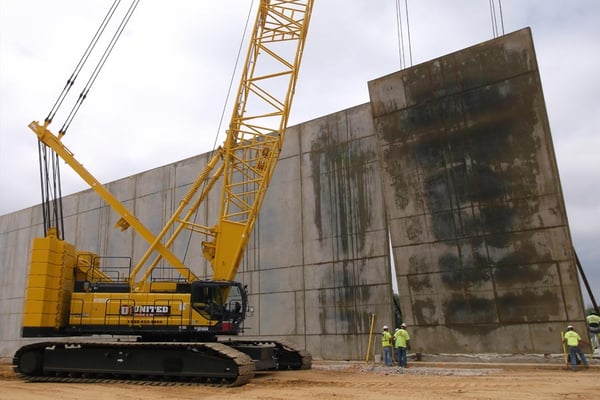 Hoisting a tilt wall panel with a Kobelco crawler crane.