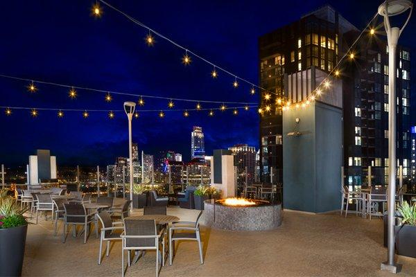 Rooftop lounge with large fire pit and downtown Austin views