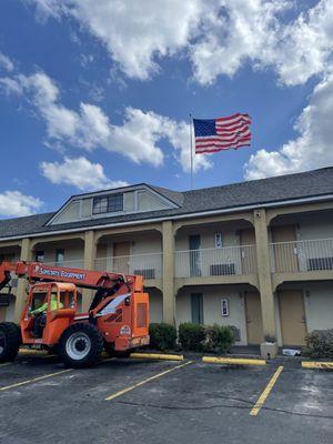 Loading shingles onto this hotel with a boom lift.