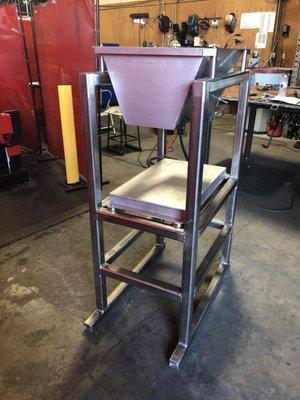 A frame and hopper made all in stainless steel. This is for cheese.