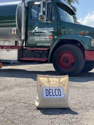 Reopening Delco bag in front of American Energy Supply Fuel Truck.