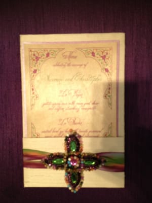 Luxury invitation enclosed in a silk pocket fold jacket with silk ribbon and rhinestone brooch embellishment.