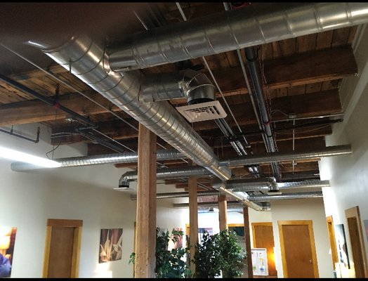 Commercial office exposed spiral ductwork; heating and AC capability