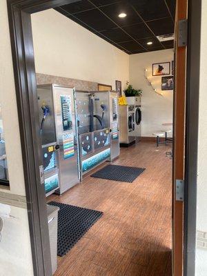 Dog wash room with too baths and dog laundry machines.