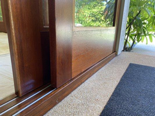 AFTER: African mahogany sliding doors restored, screen removed and glass installed, so beautiful!