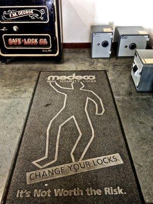 Safes, and rug with crime chalk outline - Change Your Locks. It's Not Worth the Risk. F.M. George & Safe Lock Co.