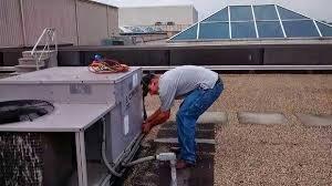 Universal Heating and Cooling servicing a (RTU) Rooftop Air Conditioner on Eastland Mall.