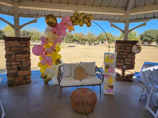 Boho loveseat with pillows and small wicker table