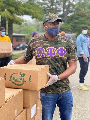 Pastor KJ handing out boxes of food at our Community Food Bank.