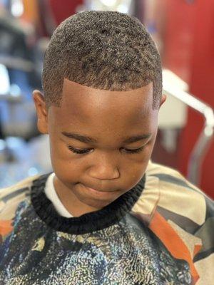 Young man with a feather fade cut with a nice crisp lining